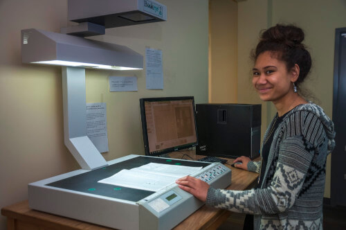 library employee scanning a library item